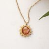 Sun necklace with orange stone, handmade brass pendant plated in 24k gold on a stainless steel chain. Vibrant celestial-inspired artisan jewelry, elegant handmade accessory, affordable wearable art by Sunny Designs small business. Κολιέ Sun με πορτοκαλί πέτρα, χειροποίητο μενταγιόν από ορείχαλκο επιχρυσωμένο 24 καράτια σε ατσάλινη αλυσίδα. Ζωντανό κόσμημα εμπνευσμένο από τα ουράνια σύμβολα, κομψό χειροποίητο αξεσουάρ, προσιτή φορετή τέχνη από τη μικρή επιχείρηση Sunny Designs.