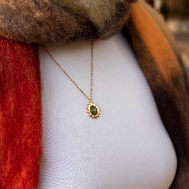 Sun necklace with khaki stone, handmade brass pendant plated in 24k gold on a stainless steel chain. Unique artisan jewelry inspired by celestial symbols, elegant and bohemian wearable art, affordable handmade accessory by Sunny Designs small business.Sun necklace with khaki stone, affordable handmade brass and gold plated celestial jewelry, Sunny Designs small business. Κολιέ Sun με χακί πέτρα, χειροποίητο μενταγιόν από ορείχαλκο επιχρυσωμένο 24 καράτια σε ατσάλινη αλυσίδα. Μοναδικό κόσμημα τέχνης εμπνευσμένο από τα ουράνια σύμβολα, κομψή και μποέμ φορετή τέχνη, προσιτό χειροποίητο αξεσουάρ από τη μικρή επιχείρηση Sunny Designs.