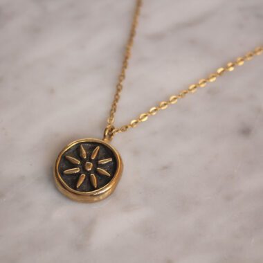 Kid of the Sun necklace with stainless steel chain and handmade brass sun pendant with patina finish. Unique artisan jewelry inspired by celestial symbols, bohemian wearable art, affordable handmade accessory by Sunny Designs small business.Κολιέ Kid of the Sun με ατσάλινη αλυσίδα και χειροποίητο μενταγιόν ήλιου από ορείχαλκο με πατίνα. Μοναδικό χειροποίητο κόσμημα εμπνευσμένο από τα ουράνια σύμβολα, μποέμ φορετή τέχνη, προσιτό αξεσουάρ από τη μικρή επιχείρηση Sunny Designs.