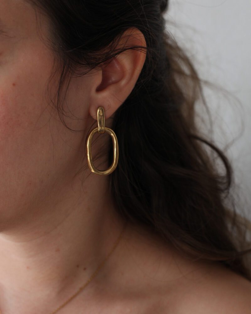 oval brass earrings, bold shape earrings, minimalist statement earrings, handmade Greek jewelry, Sunny Designs earrings, sculptural brass jewelry, σκουλαρίκια οβάλ, τολμηρά σκουλαρίκια, σκουλαρίκια με κίνηση, κομψά σκουλαρίκια ορείχαλκος, Sunny Designs χειροποίητα, minimal σκουλαρίκια