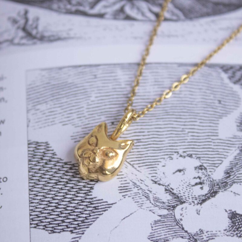 Cat face necklace, handmade pendant in 24k gold plated brass on stainless steel chain, artisan animal jewelry, boho chic necklace for cat lovers, symbolic feline pendant, playful handmade accessory, affordable small business jewelry by Sunny Designs Κολιέ Cat Face, χειροποίητο μενταγιόν γάτας από ορείχαλκο επιχρυσωμένο 24 καράτια σε ατσάλινη αλυσίδα, boho chic κόσμημα για λάτρεις της γάτας, συμβολικό χειροποίητο κόσμημα ζώων, παιχνιδιάρικο αξεσουάρ Sunny Designs