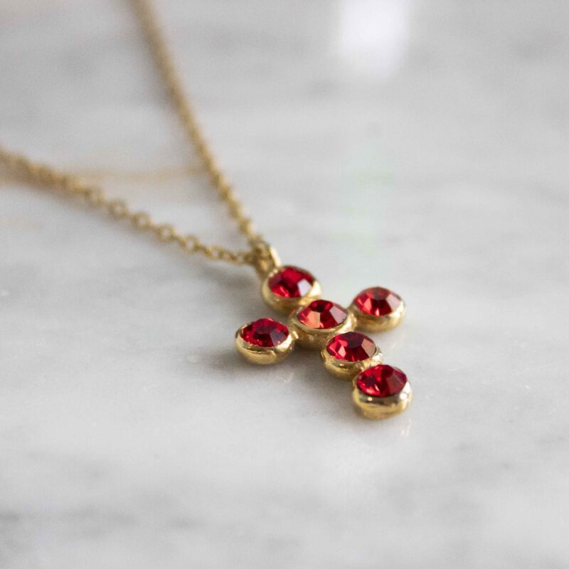 Heavenly Cross necklace with red stone, handmade artisan pendant in 24k gold plated brass on durable stainless steel chain, symbolic spiritual jewelry, boho cross necklace, unique handmade small business accessory by Sunny Designs Χειροποίητο κολιέ σταυρός Heavenly Cross με κόκκινη πέτρα, επιχρυσωμένο μενταγιόν από ορείχαλκο, ατσάλινη αλυσίδα, affordable bohemian artisan jewelry, συμβολικό κόσμημα πίστης από τη Sunny Designs