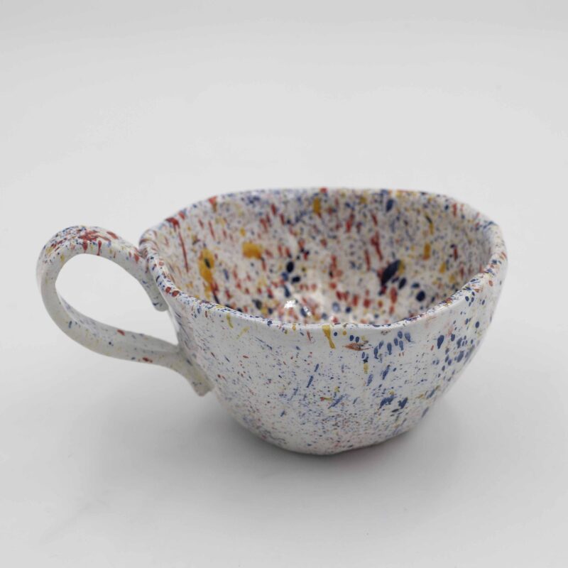 Playful mug splashed with colorful dots in a Pollock-inspired design. A unique and eye-catching addition to your coffee mug collection. (keywords: mug, colorful dots, pollock style, coffee mug, unique mug) Παιχνιδιάρικο φλιτζάνι με πολύχρωμες βούλες εμπνευσμένο από τον Πόλοκ. Μια μοναδική και εντυπωσιακή προσθήκη στη συλλογή σας από φλιτζάνια καφέ. (keywords: φλιτζάνι, πολύχρωμες βούλες, στυλ Πόλοκ, φλιτζάνι καφέ, μοναδικό φλιτζάνι)