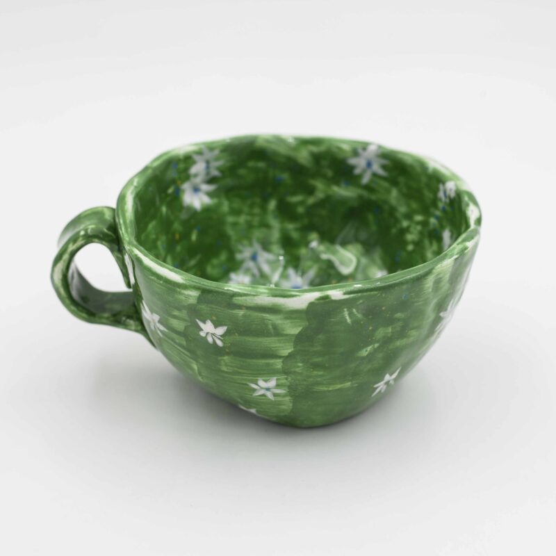 Blooming lovely! This hand-painted mug features a charming floral design on a fresh green background. A delightful addition to your tea or coffee ritual. (keywords: mug, floral design, green mug, hand-painted mug, tea mug, coffee mug) Ανθισμένη ομορφιά! Αυτό το χειροποίητο φλιτζάνι διαθέτει χαριτωμένο floral σχέδιο σε φόντο φρέσκου πράσινου χρώματος. Μια απολαυστική προσθήκη στο τελετουργικό σας τσαγιού ή καφέ. (keywords: φλιτζάνι, floral σχέδιο, πράσινο φλιτζάνι, χειροποίητο φλιτζάνι, φλιτζάνι τσαγιού, φλιτζάνι καφέ)