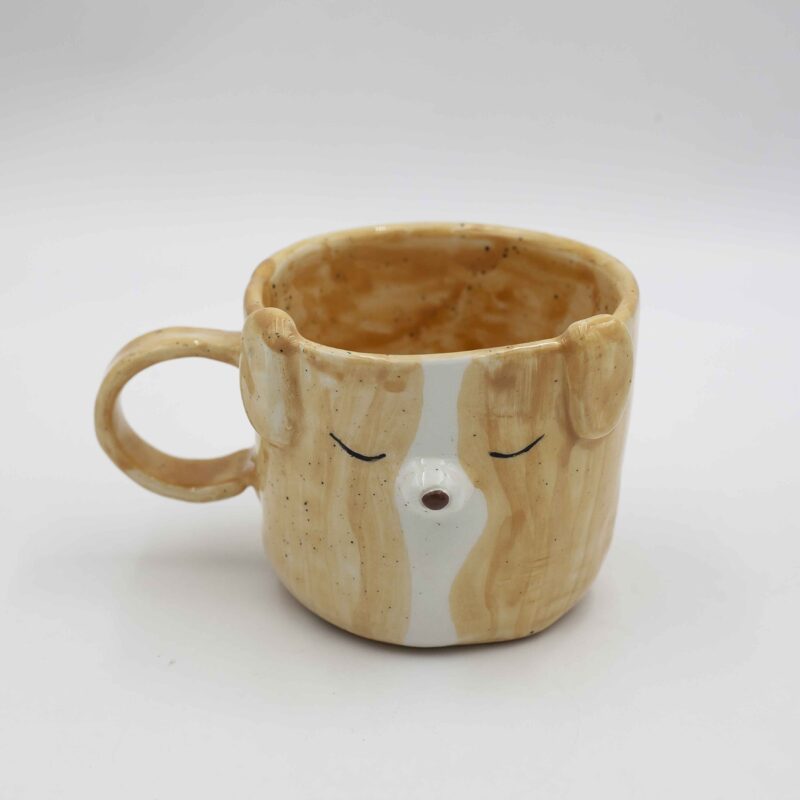 Whimsical handmade ceramic mug featuring a charming dog face design. Perfect for dog lovers and coffee enthusiasts. Φανταστικό χειροποίητο κεραμικό φλιτζάνι με γοητευτικό σχέδιο προσώπου σκύλου. Ιδανικό για λάτρεις των σκύλων και του καφέ.