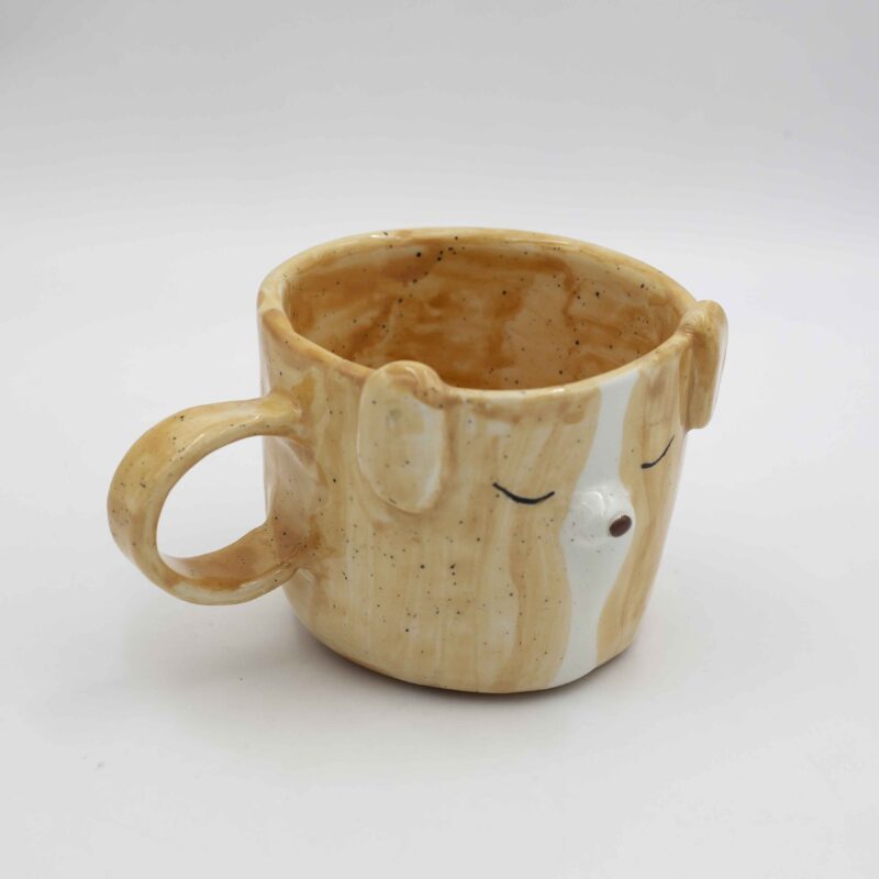 Whimsical handmade ceramic mug featuring a charming dog face design. Perfect for dog lovers and coffee enthusiasts. Φανταστικό χειροποίητο κεραμικό φλιτζάνι με γοητευτικό σχέδιο προσώπου σκύλου. Ιδανικό για λάτρεις των σκύλων και του καφέ.