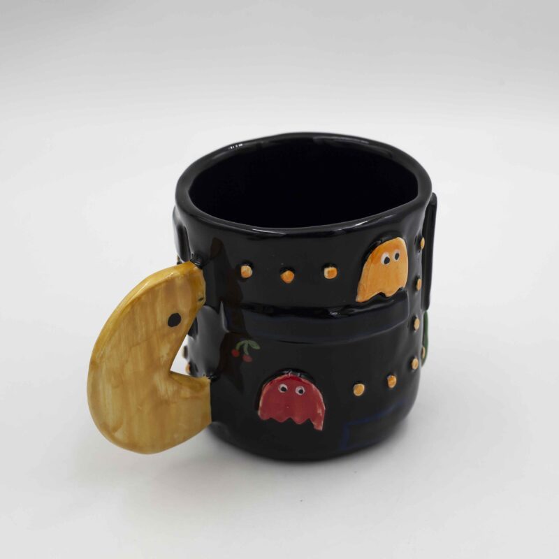 Nostalgic handmade ceramic mug featuring a classic Pac-Man design. Perfect for retro gamers and coffee lovers. Νοσταλγικό χειροποίητο κεραμικό φλιτζάνι με κλασικό σχέδιο Pac-Man. Ιδανικό για λάτρεις των retro παιχνιδιών και του καφέ.