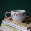 Beautiful handmade ceramic Christmas mugs featuring festive designs like gingerbread cookies and Christmas trees, perfect for cozy winter mornings. Artisan-crafted with care, ideal for gifting or enjoying hot cocoa. Unique holiday mugs made with love. "Όμορφες χειροποίητες κεραμικές κούπες για τα Χριστούγεννα, με γιορτινά σχέδια όπως μπισκότα τζίντζερμαν και χριστουγεννιάτικα δέντρα. Ιδανικές για ζεστά πρωινά του χειμώνα. Δημιουργημένες με μεράκι, τέλειες για δώρα ή για απολαυστική ζεστή σοκολάτα. Μοναδικές εορταστικές κούπες φτιαγμένες με αγάπη