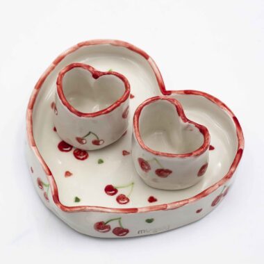 Handmade ceramic heart-shaped set, featuring a large heart plate and two matching heart cups, beautifully hand-painted with cherries. A romantic and charming design, perfect for sharing special moments over coffee or tea. Ideal for Valentine's Day, anniversaries, or as a unique gift for someone you love.