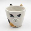 Adorable handmade ceramic cat mugs with a 3D snout and ears, bringing a playful and cozy touch to your coffee or tea time. Designed for cat lovers, these unique mugs combine artistic craftsmanship with functionality, making them the perfect gift or collectible piece. Χαριτωμένες χειροποίητες κεραμικές κούπες γάτας με τρισδιάστατη μουσούδα και αυτιά, που προσθέτουν μια παιχνιδιάρικη και ζεστή πινελιά στον καφέ ή το τσάι σας. Σχεδιασμένες για λάτρεις των γατών, αυτές οι μοναδικές κούπες συνδυάζουν την καλλιτεχνική δημιουργία με την πρακτικότητα, αποτελώντας το τέλειο δώρο ή συλλεκτικό κομμάτι.