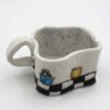 Handmade surreal ceramic mugs with unique artistic shapes, featuring dreamy paintings of ceramic pots, the moon, sun, and stars. A fusion of functionality and fantasy, these celestial-inspired mugs are perfect for lovers of mystical aesthetics and handmade pottery. Each piece is a work of art, bringing cosmic beauty to your daily rituals! Χειροποίητες σουρεαλιστικές κεραμικές κούπες με μοναδικά καλλιτεχνικά σχήματα, διακοσμημένες με ονειρικές ζωγραφιές από κεραμικά αγγεία, το φεγγάρι, τον ήλιο και τα αστέρια. Ένας μαγικός συνδυασμός λειτουργικότητας και φαντασίας, ιδανικός για όσους αγαπούν τη μυστικιστική αισθητική και την κεραμική τέχνη. Κάθε κούπα είναι ένα έργο τέχνης που φέρνει την κοσμική ομορφιά στις καθημερινές σας στιγμές!