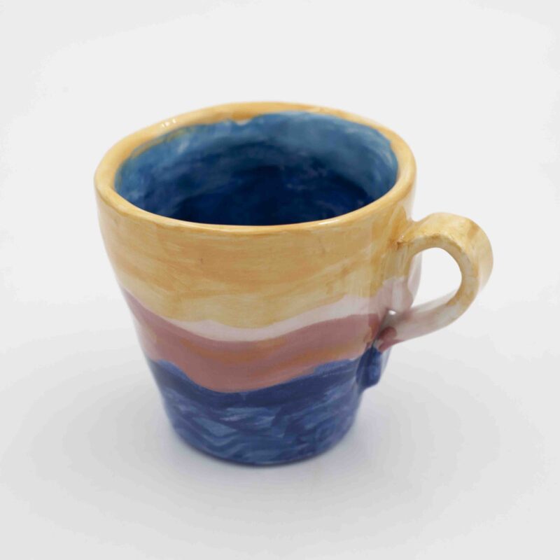 Handmade ceramic mug with a hand-painted sunset landscape, capturing warm hues and dreamy horizons. A unique coffee mug inspired by nature, perfect for tea or coffee lovers and an ideal gift.