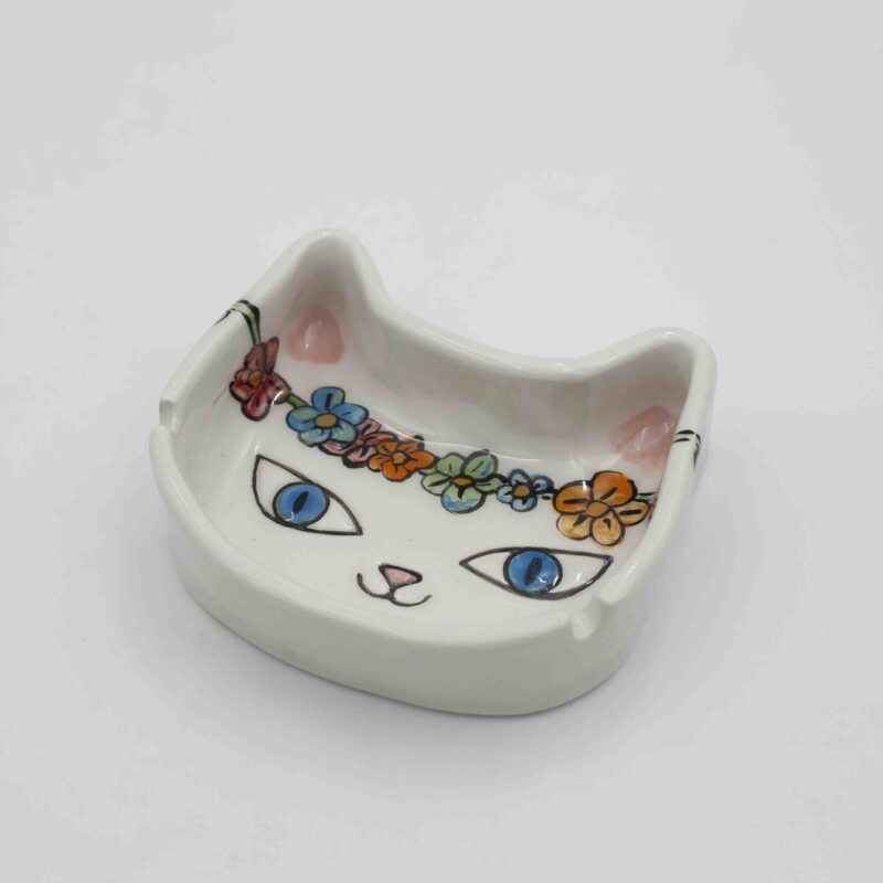 white cat ashtray with flowers.