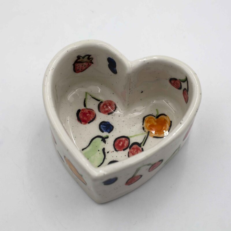 Handmade heart-shaped ceramic mugs, perfect for Valentine's Day and romantic moments. Each mug is decorated with charming hand-painted details, featuring cherries, an array of fruits, delicate flowers, and tiny hearts. A unique and thoughtful gift for loved ones, blending artistic beauty with everyday warmth and love. Χειροποίητες κεραμικές κούπες σε σχήμα καρδιάς, ιδανικές για την Ημέρα του Αγίου Βαλεντίνου και ρομαντικές στιγμές. Κάθε κούπα είναι διακοσμημένη με χαριτωμένες, ζωγραφισμένες στο χέρι λεπτομέρειες, όπως κεράσια, διάφορα φρούτα, λεπτεπίλεπτα λουλούδια και μικρές καρδιές. Ένα μοναδικό και τρυφερό δώρο για τα αγαπημένα σας πρόσωπα, που συνδυάζει την τέχνη με τη ζεστασιά της καθημερινότητας.