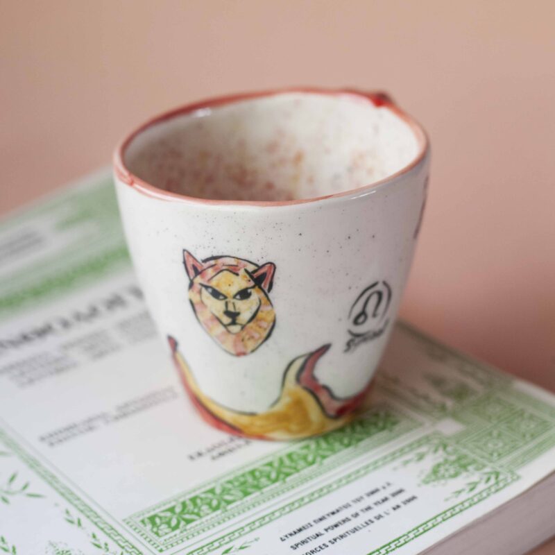 handmade ceramic mug about leo. with leo vibes, symbols and planets. Χειροποίητη κεραμική κούπα του λέοντα με φωτιές και σύμβολα και πλανήτες.