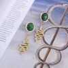 spiral serpent earrings, brass earrings with green stone, symbolic spiral jewelry, handmade statement earrings, brass moving earrings, Sunny Designs Από ορείχαλκο χωρίς νικέλιο. Απόφυγε την επαφή με νερό, αρώματα ή υγρασία. Καθάριζέ τα με ειδικό πανί καθαρισμού ορείχαλκου για να διατηρούν τη λάμψη τους.