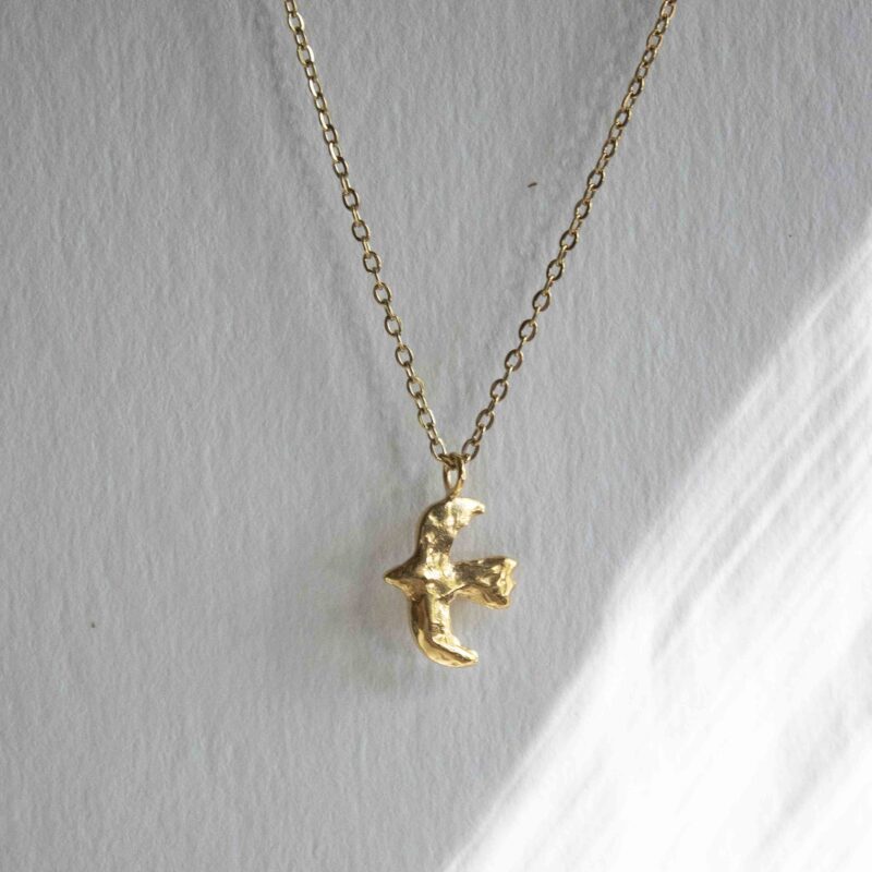 Bird of Freedom necklace, elegant 24k gold plated brass artisan pendant depicting a flying bird, boho chic symbolic jewelry, handmade jewelry for free-spirited style by Sunny Designs