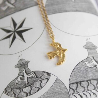 Bird of Freedom necklace, handmade pendant in 24k gold plated brass on stainless steel chain, symbolic bird jewelry representing freedom, inspiration, and independence, boho chic artisan necklace by Sunny Designs