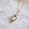 Harmony necklace with white stone, handmade artisan pendant in 24k gold plated brass on stainless steel chain, symbolic circle jewelry, boho gemstone necklace, unique handmade small business accessory by Sunny Designs Χειροποίητο κολιέ Harmony με λευκή πέτρα, μενταγιόν από επιχρυσωμένο ορείχαλκο και ατσάλινη αλυσίδα, affordable bohemian artisan jewelry, κομψό και πνευματικό κόσμημα Sunny Designs