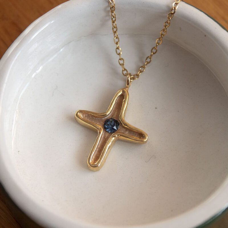 Maria’s Cross necklace with blue Swarovski stone, handmade artisan pendant in 24k gold plated brass on durable stainless steel chain, symbolic spiritual jewelry, boho cross necklace, unique handmade small business accessory by Sunny Designs , Κολιέ Maria’s Cross με μπλε πέτρα Swarovski, χειροποίητο μενταγιόν σταυρού από ορείχαλκο επιχρυσωμένο 24 καράτια σε ατσάλινη αλυσίδα, πνευματικό κόσμημα, boho χειροποίητο αξεσουάρ, μοναδικό κόσμημα μικρής επιχείρησης Sunny Designs