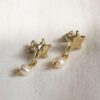 Shining Star earrings with moving pearl, handmade brass star earrings, celestial-inspired artisan jewelry, affordable wearable art, unique statement accessories, elegant handmade earrings by Sunny Designs small business.Σκουλαρίκια Shining Star με κινούμενο μαργαριτάρι, χειροποίητα σκουλαρίκια αστέρι από ορείχαλκο, κοσμήματα εμπνευσμένα από τον ουρανό, προσιτά κοσμήματα-έργα τέχνης, μοναδικά statement αξεσουάρ, κομψά χειροποίητα σκουλαρίκια από τη μικρή επιχείρηση Sunny Designs.