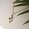 Small snake necklace, handmade serpent pendant in 24k gold plated brass on stainless steel chain, symbolic snake jewelry, boho chic necklace, unique handmade small business accessory by Sunny Designs Κολιέ Small Snake, χειροποίητο μενταγιόν φιδιού από ορείχαλκο επιχρυσωμένο 24 καράτια σε ατσάλινη αλυσίδα, συμβολικό κόσμημα, boho χειροποίητο αξεσουάρ από τη Sunny Designs
