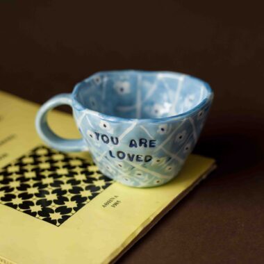 beautiful handmade mug with the quote you are loved. painted with blue tiles style for more autumn vibes. κεραμική χειροποίητη κούπα με ζωγραφισμένα πλακάκια και μήνυμα που γράφει είσαι αγαπητός. τέλεια για ζεστά ροφήματα και ένα ξεχωριστό δώρο.