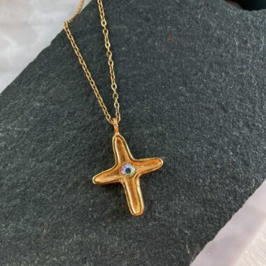 A symbol of grace and faith, the Maria’s Cross necklace by Sunny Designs features a uniquely minimal yet elegant cross adorned with a sparkling prismatic stone at its center. Handcrafted with care, this necklace is made from high-quality materials and designed to be a timeless addition to your jewelry collection. Perfect for meaningful gifts or everyday elegance with spiritual significance.