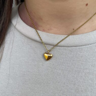 The Mini Bold Heart Necklace by Sunny Designs radiates charm and warmth through its simple yet confident design. Handmade from premium brass, this dainty heart pendant symbolizes love and individuality. With its polished finish and timeless style, it’s perfect for everyday wear or as a meaningful gift for someone special.