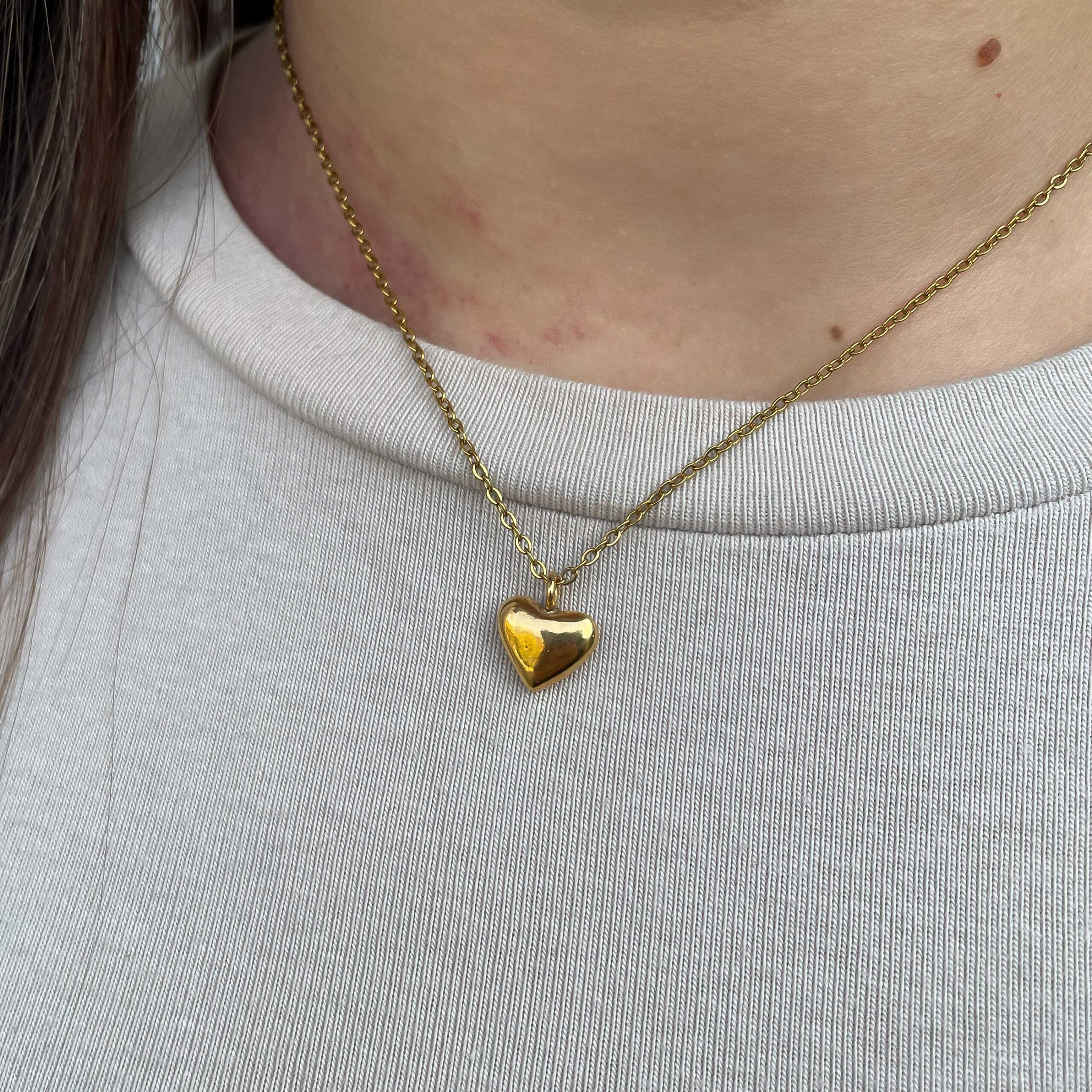 The Mini Bold Heart Necklace by Sunny Designs radiates charm and warmth through its simple yet confident design. Handmade from premium brass, this dainty heart pendant symbolizes love and individuality. With its polished finish and timeless style, it’s perfect for everyday wear or as a meaningful gift for someone special.