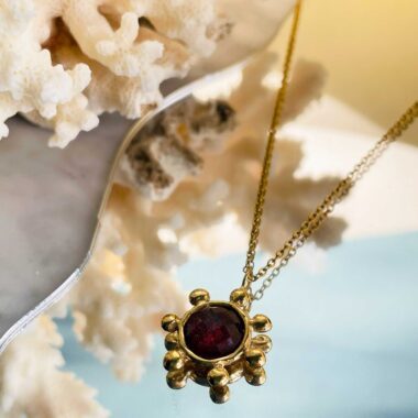 The Starfire Necklace by Sunny Designs radiates passion and confidence with its striking red stone. Handmade from brass, it symbolizes strength, love, and vitality — a perfect statement piece for every occasion.