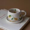 cute ceramic handmade cup with a saucer and fruits. Lemons, cherries and tangerines. perfect for espresso and single turkish coffee. Γλυκά χειροποίητα κεραμικά κουπάκια με πιατάκι και φρουτάκια. Κατάλληλη για εσπρέσο και μονό ελληνικό καφέ.