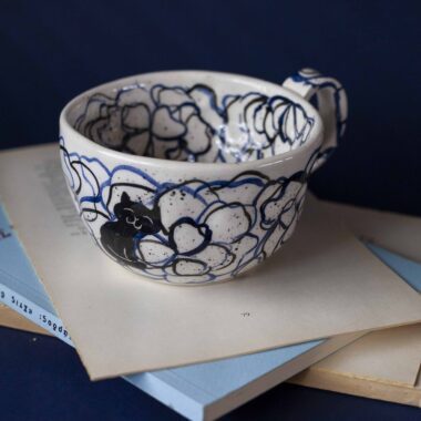 Χειροποίητα κεραμικά τασάκια και κούπες με σχέδια γατών, κάθε μία με ξεχωριστή έκφραση και χαρακτήρα. Πλασμένες και ζωγραφισμένες στο χέρι με ζωηρά χρώματα και καλλιτεχνικές λεπτομέρειες, ιδανικές για τους λάτρεις των γατών και της χειροποίητης τέχνης. Handmade ceramic cat-themed ashtrays and mugs, each featuring unique cat expressions and artistic charm. Hand-shaped and hand-painted with lively colors and creative details — perfect for cat lovers and fans of handmade artistry.