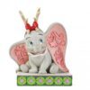 “Disney Traditions figurine of Dumbo wearing festive reindeer antlers, hand-painted with Jim Shore folk-art patterns.”