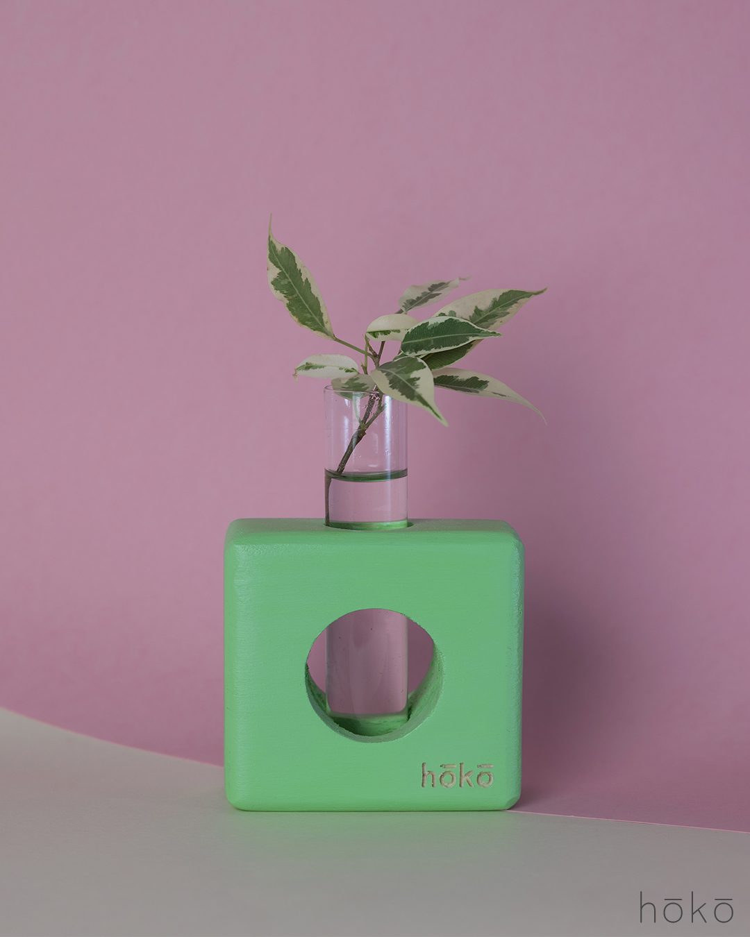 square light green wooden vase hoko with a testing tube for water. it helps the roots to grow and it gives a natural beauty in our homes.