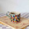 Small handmade ceramic mug with colorful brush strokes, beige speckled clay, artistic pottery Μικρή χειροποίητη κεραμική κούπα με πολύχρωμες πινελιές, μπεζ πηλός με σαμότ, καλλιτεχνικό σχέδιο