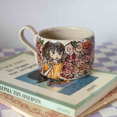 Handmade ceramic mug with Chihiro following Haku among roses, beige speckled clay, hand-painted anime scene Χειροποίητη κεραμική κούπα με την Chihiro να ακολουθεί τον Haku ανάμεσα σε τριαντάφυλλα, μπεζ πηλός με σαμότ