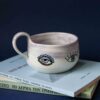 χειροποίητη κεραμική κούπα με μάτια. handmade ceramic mug with evil eyes on it.