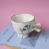 handmade ceramic cup with flowers for espresso. χειροποίητο κεραμικό κουπάκι με λουλούδια για εσπρέσσο.