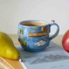 handmade ceramic 3d mug from super mario game. light blue shades and mushroom on the handle. χειροποίητη κεραμική κούπα από πίστα από το σούπερ Μάριο . με 3ντι στοιχεία σε γαλάζιους τόνους με 3ντι μανιταράκι στο χερούλι.
