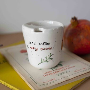 perfect halloween cup with a hole. its about iced coffee and scary movies. halloween vibes and witchy things. χειροποίητο κεραμικό ποτηράκι που είναι για το halloween. έχει πάνω τρομακτικά και μάγισσας στοιχεία.