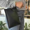 leather wallet with one metallic hoop for handle. δερμάτινο πορτοφόλι με κρίκο για χερούλι.